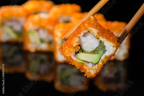 close up of sushi with caviar on a stick