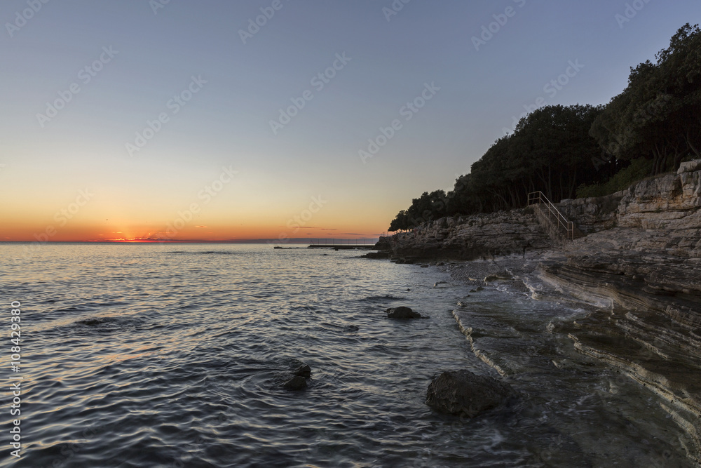 Sunset rocky beach in Istra, Croatia.
