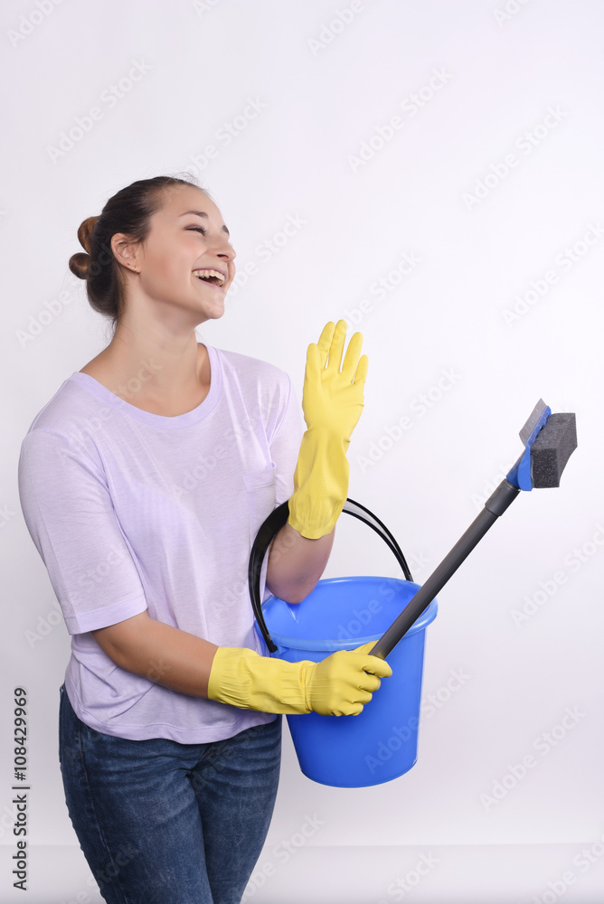 young housewife holding cleaning products. young housewife holding cleaning products.