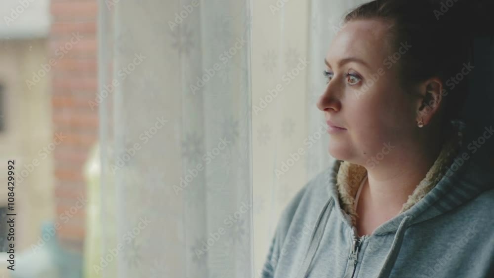 Woman looking out the window and laughs. Woman looking out the window and laughs.