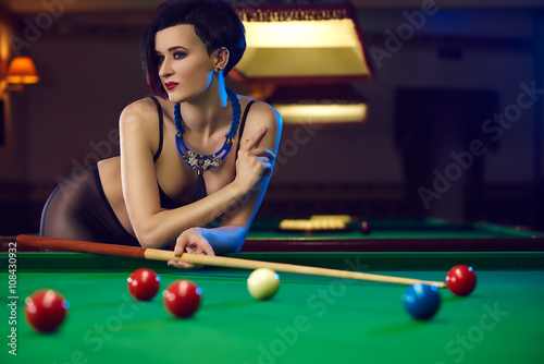 Hot sexy young woman at billiards club playing snooker Photos | Adobe Stock