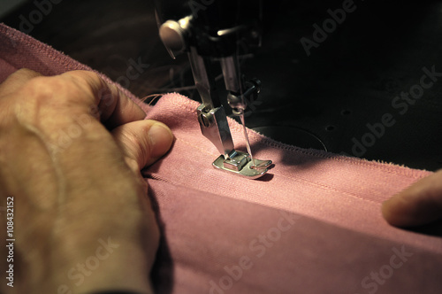 Fototapeta Naklejka Na Ścianę i Meble -  Dressmaker at work on a sewing machine