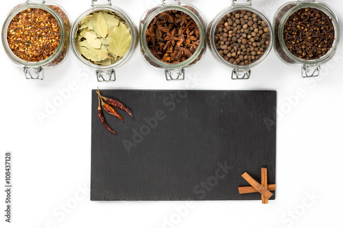 Spices and herbs in jars. Food  cuisine ingredients. Wooden board
