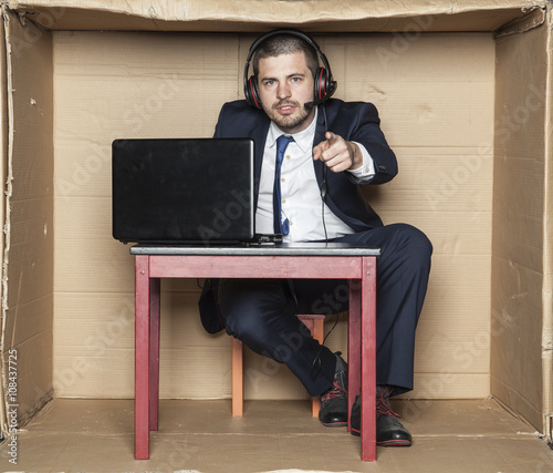 young businessman pointing at you, office situation,  photo