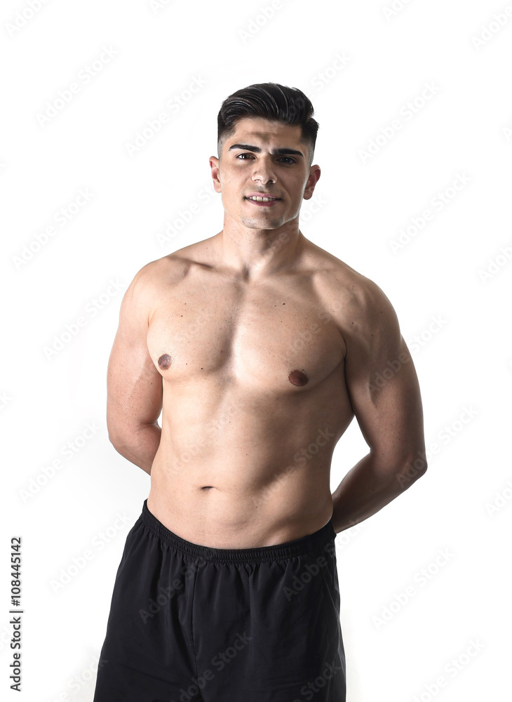 young handsome sport man posing with strong ripped naked torso looking cool and happy isolated on white