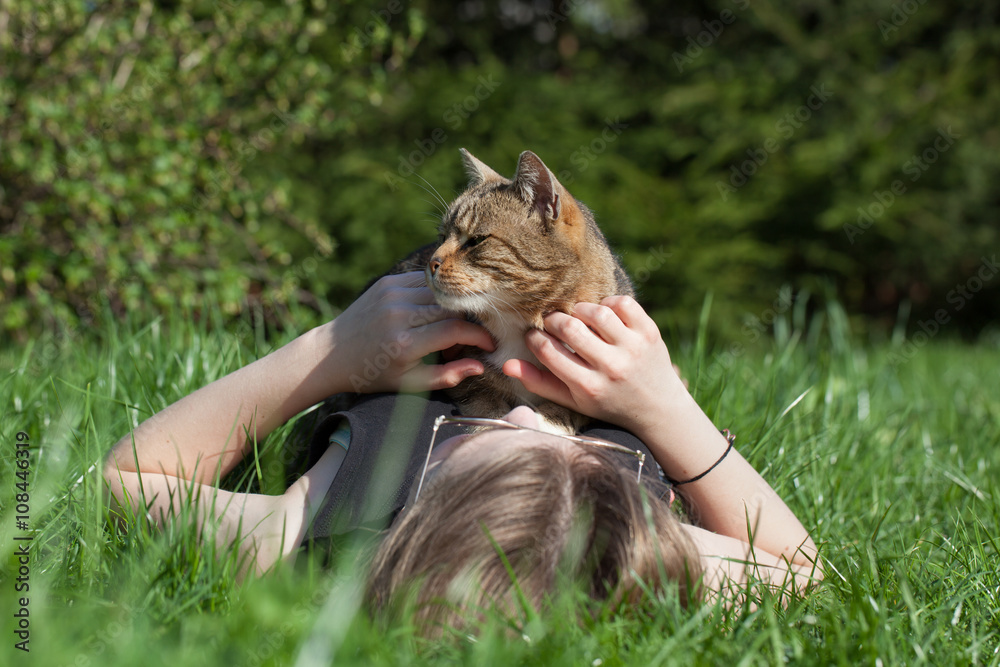 Woman petting cat in the garden