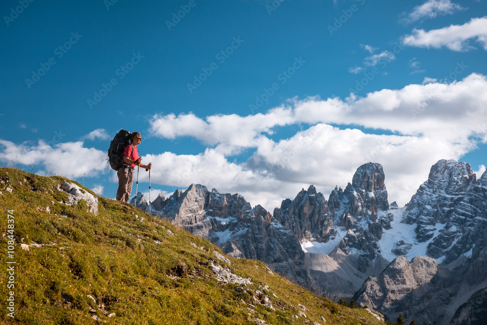 hiker in front of Alps mountains