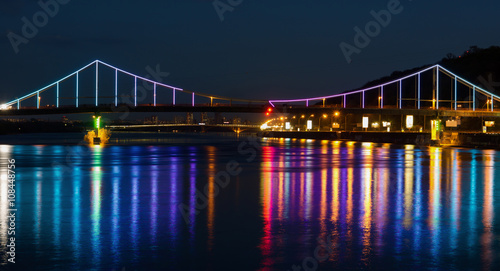 Lights night city and bridge with reflections on the river