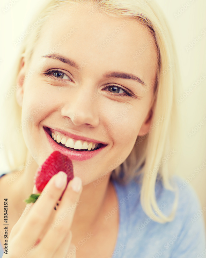 happy woman eating strawberry at home happy woman eating strawberry at home