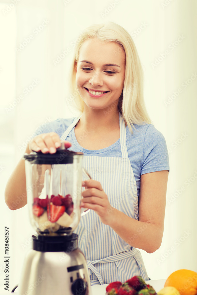 smiling woman with blender preparing shake at home smiling woman with blender preparing shake at home
