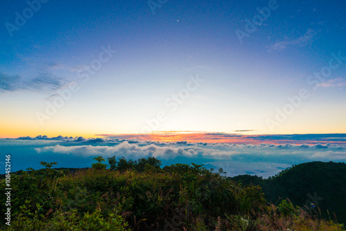 Sunrise on peak of mountain with fog white cloud