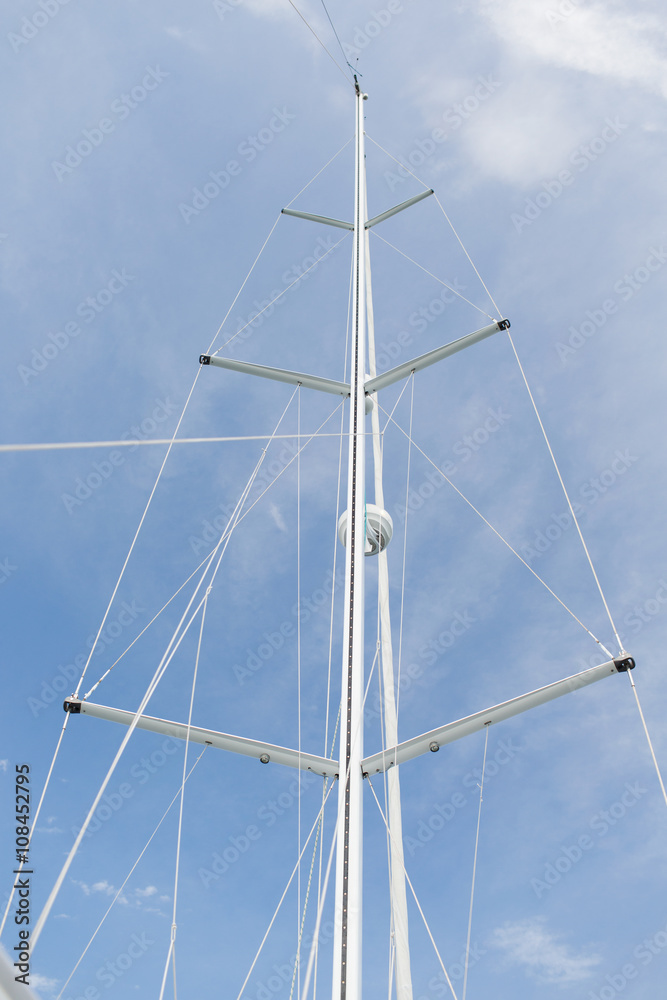 close up of sailboat mast over blue sky close up of sailboat mast over blue sky