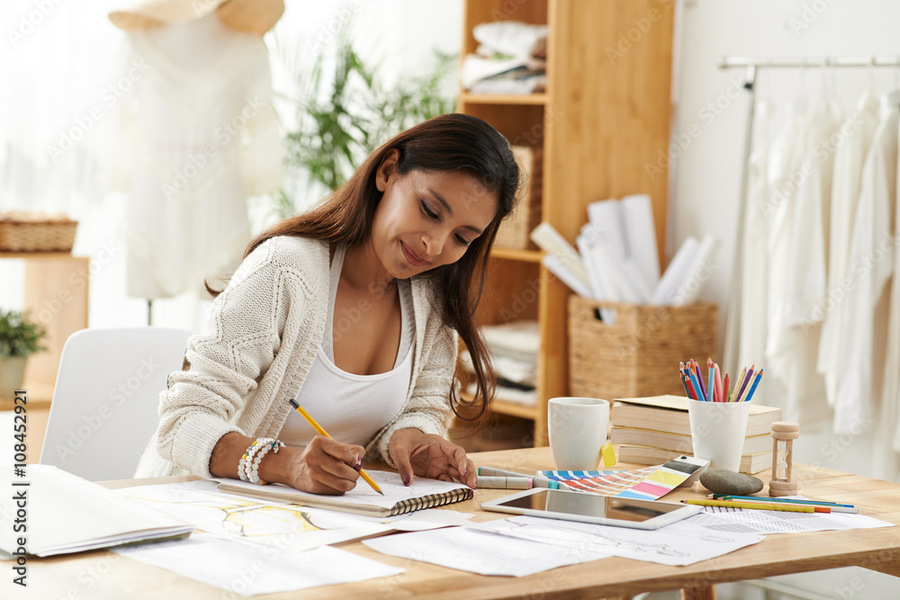 Female fashion designer enjoying working in studio Female fashion designer enjoying working in studio