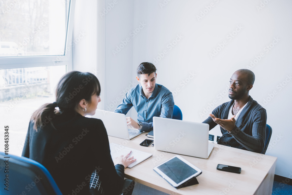 Group of contemporary multiethnic business people working together using multimedia devices like smart phone and tablet - working, business, start up concept Group of contemporary multiethnic business people working together using multimedia devices like smart phone and tablet - working, business, start up concept