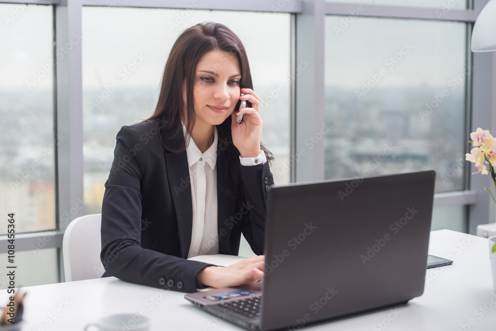 Business woman with notebook in office, workplace, talking on phone Business woman with notebook in office, workplace, talking on phone