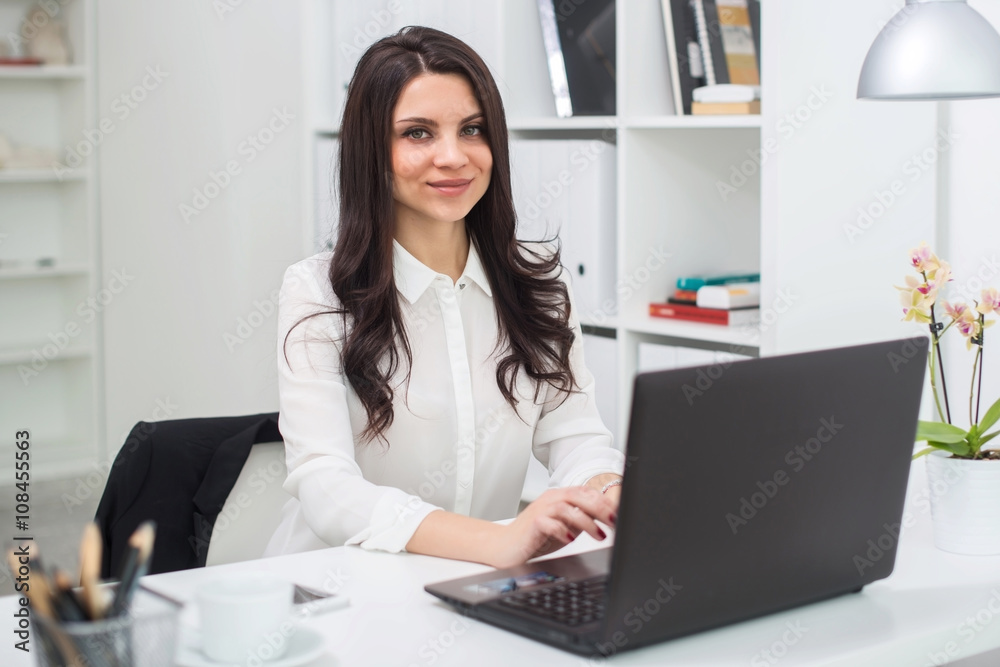 Young business woman with notebook in the office, workplace Young business woman with notebook in the office, workplace