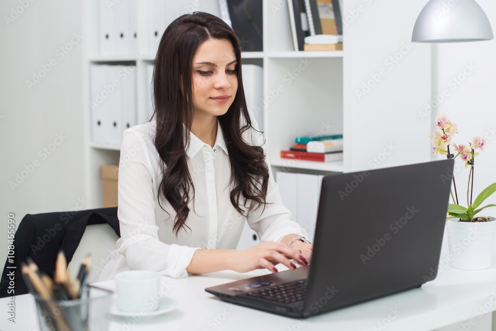 Young business woman with notebook in the office, workplace Young business woman with notebook in the office, workplace
