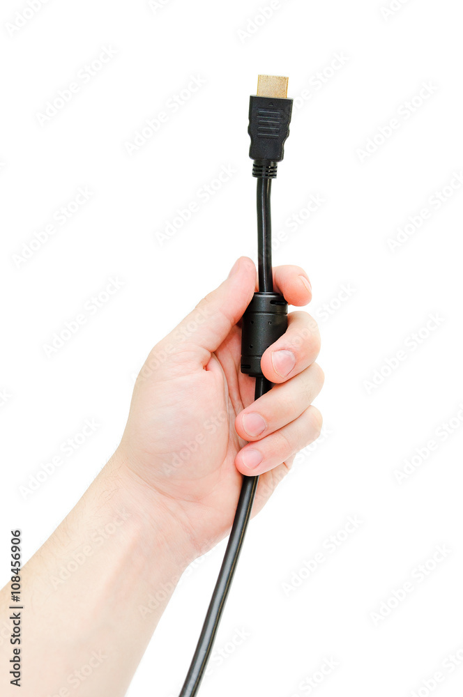 The person connects a cable. A black wire of hdmi in a hand at the man on a white background. It is isolated.