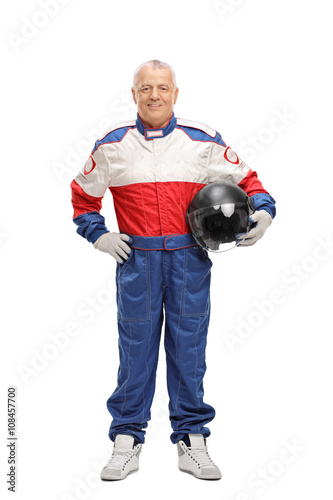 Mature man in racing suit holding helmet