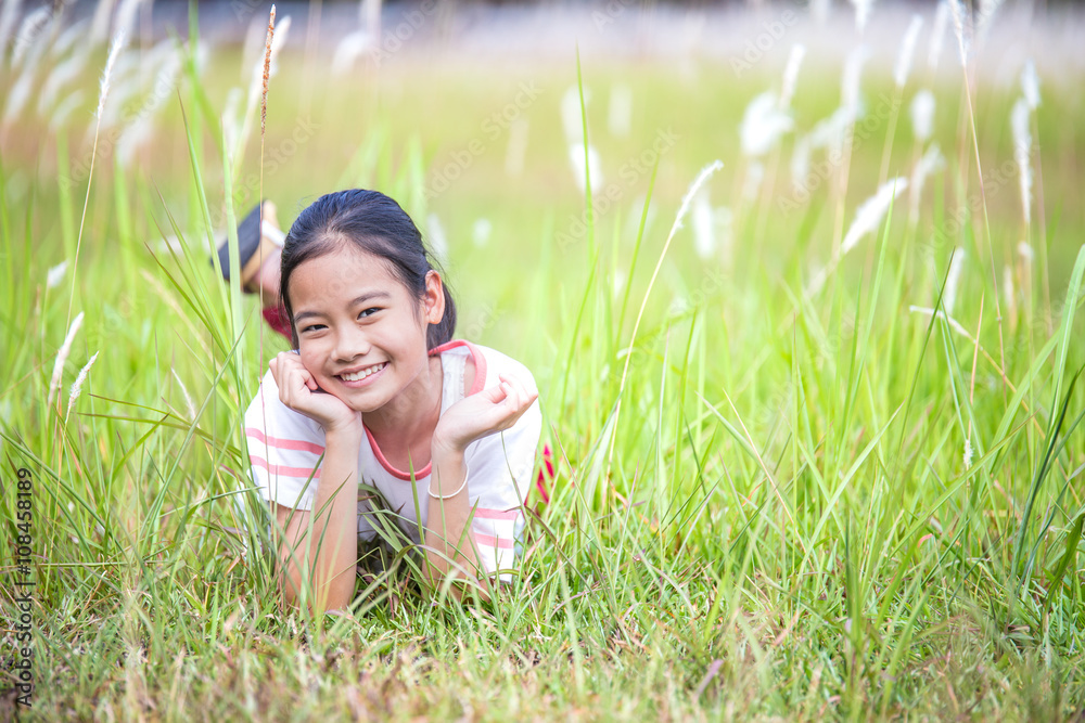 Beautiful little girl at the park looking very happy Beautiful little girl at the park looking very happy