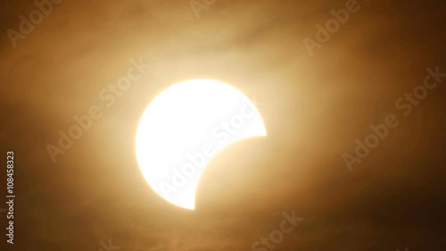 partly solar eclipse when sun rise in Thailand with cloud flow
