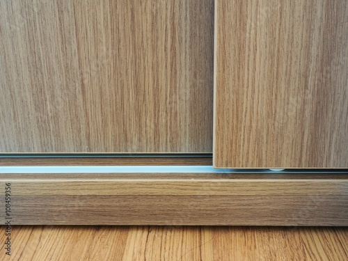Close up of slide wooden door and rail
