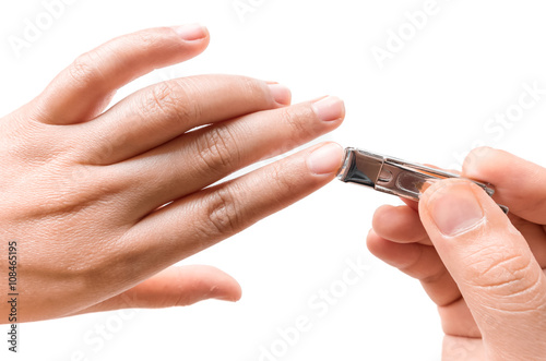Closeup women cut fingernails on white background