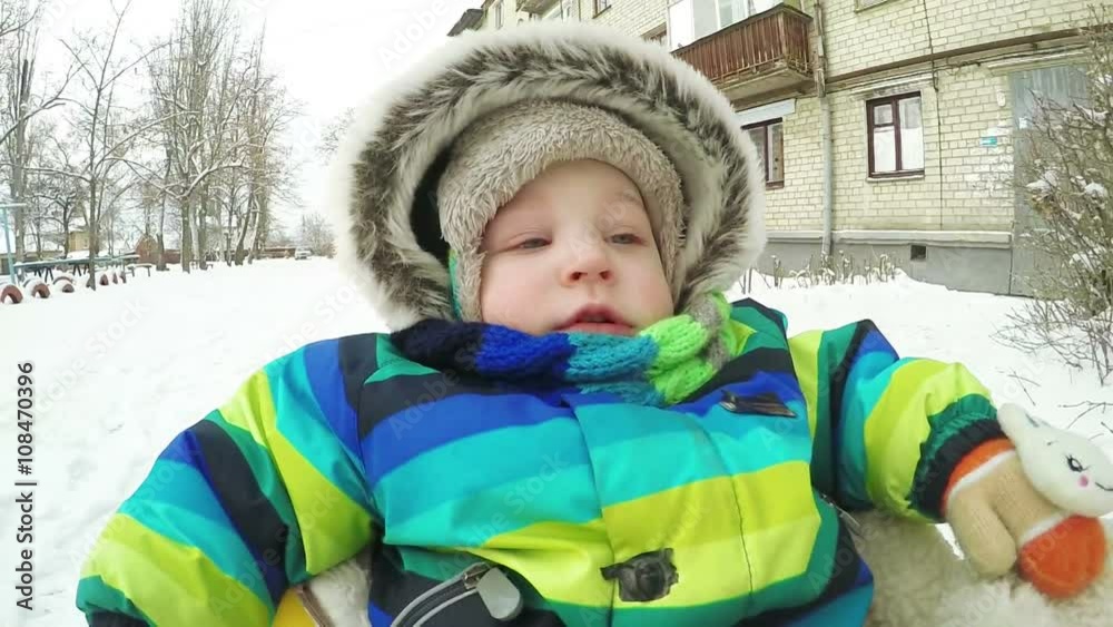 Child on sled in winter