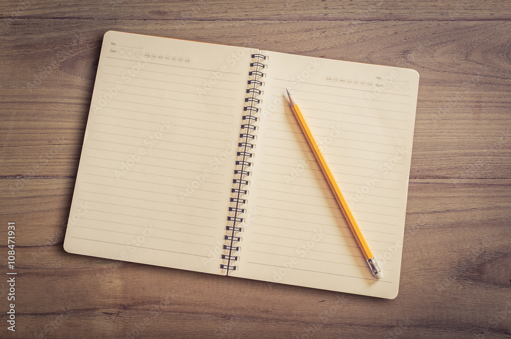 open notebook and pencil on wood background open notebook and pencil on wood background