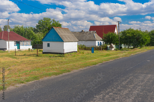 Summer landscape with asphalt road through small remote village  Stepanivka in Poltavskaya oblast, Ukraine