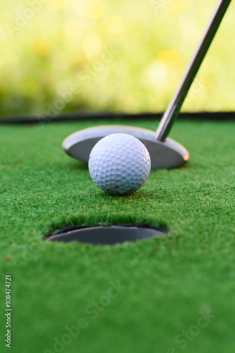 Golf field hole with cross and ball suggesting achievement of goals concept