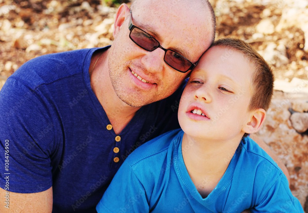 Fototapeta premium Portrait of father with son outdoors