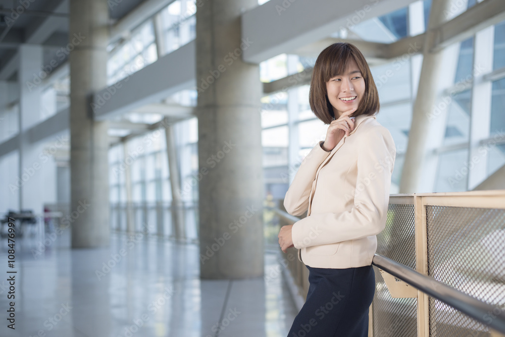 Attractive asian business woman smiling outside office Attractive asian business woman smiling outside office