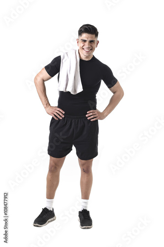 young attractive sport man with fit strong body holding towel on his shoulder smiling happy