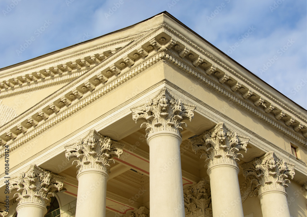 The ornate columns and a pediment in a style of classical architecture.