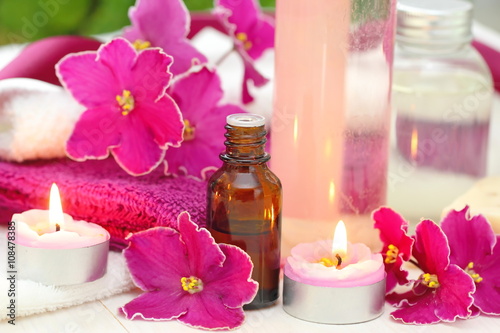 SPA setting with candles, aroma oil and violets