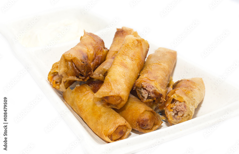 fried rolls with garlic sauce on a white background