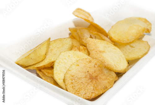 fried potatoes on a white plate in a restaurant