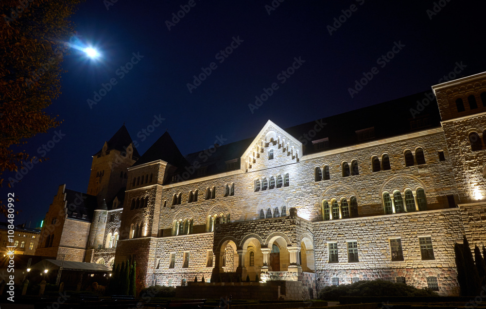 emperors castle  and moon in night in Poznan, Poland .