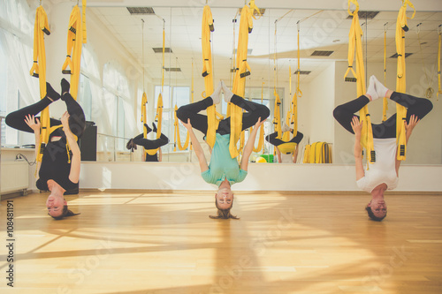 Group of girls doing aerial fly yoga