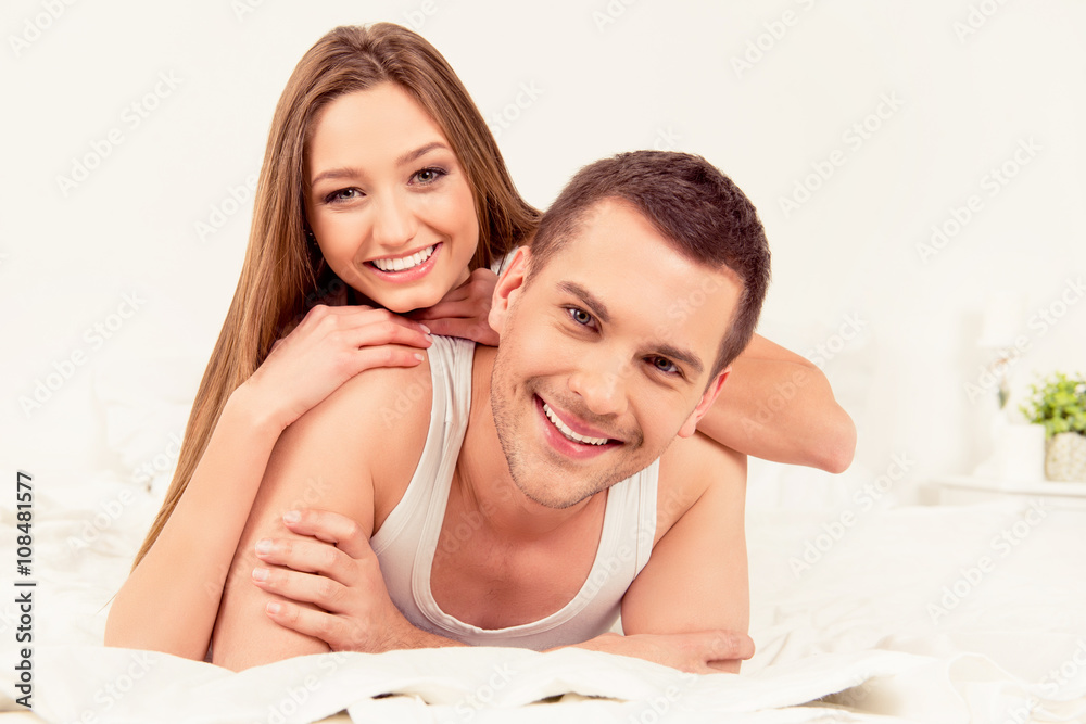 Portrait of happy young couple in love huging in bed Portrait of happy young couple in love huging in bed