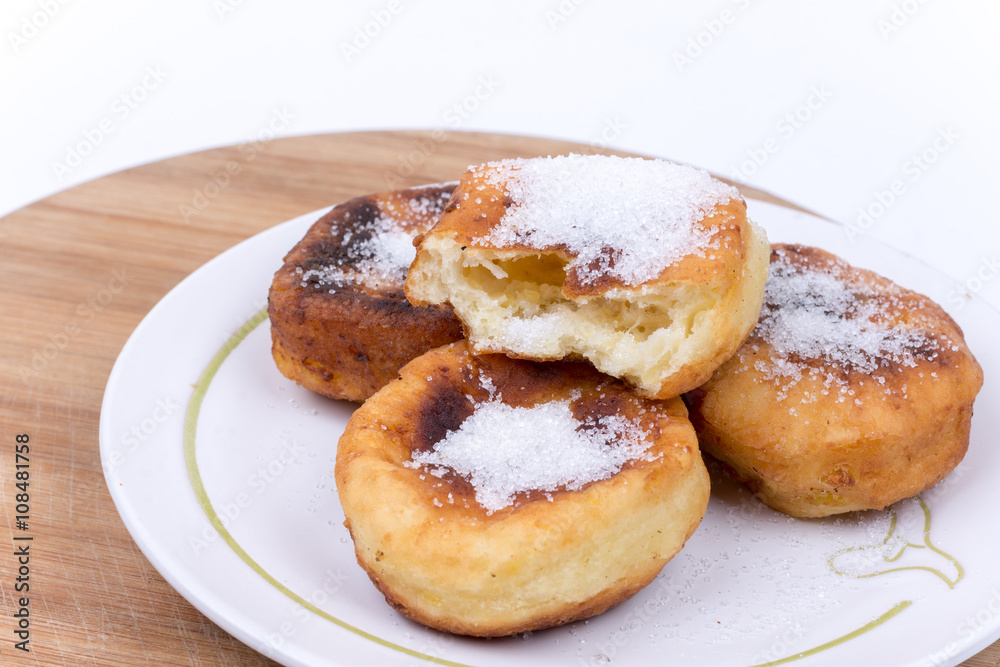 Homemade donuts with sugar over white background