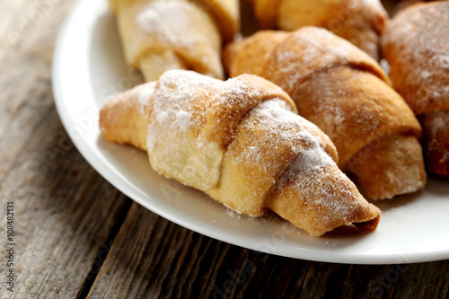 Fresh homemade croissants on a grey wooden table