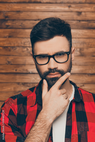 Close up portrait of serious man in  spectakles thinking about s photo