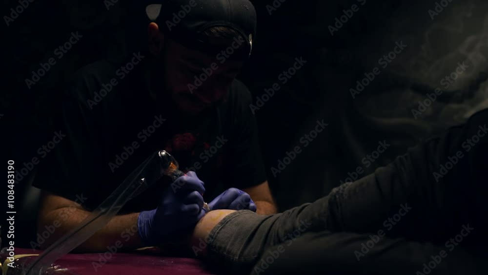 Tattoo master making tattoo. Close up. Tattoo master making tattoo. Close up.