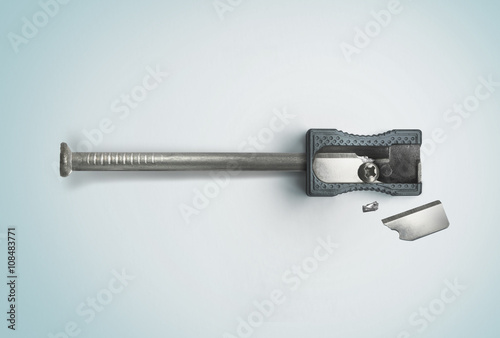 Nail and a broken sharpener. Creative concept. Safety, destruction. Top view