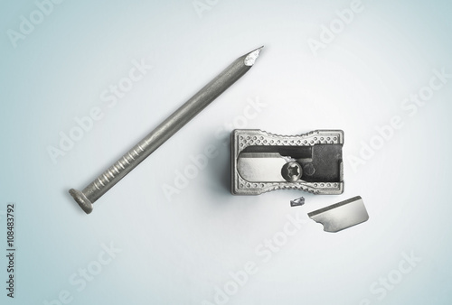 Nail and a broken sharpener. Creative concept. Safety, destruction. Top view