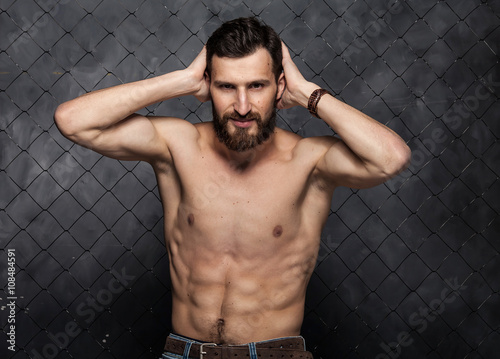 Canvas Print Shirtless muscular sexy bearded guy with beard showing his great body