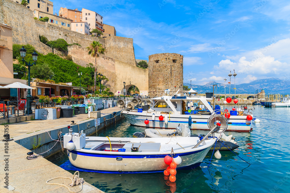 Typical old fishing boats in Calvi port on sunny summer day, Corsica island, France