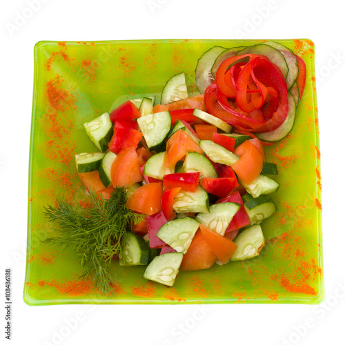 sliced tomato and cucumber with lettuce isolated on white